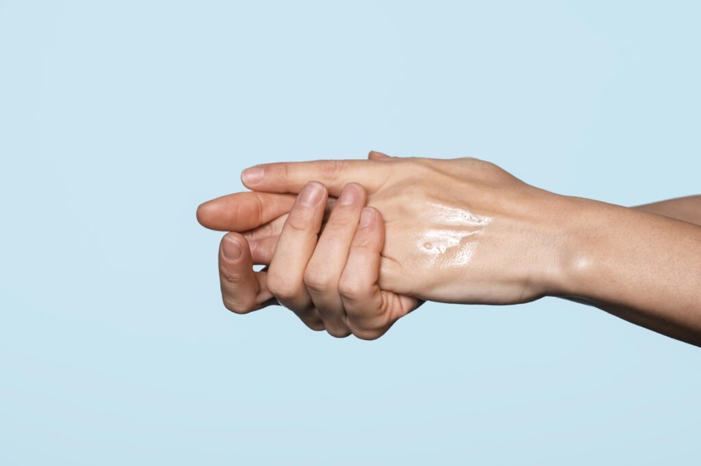 applying coconut oil or moisturizer on hand before Holi.